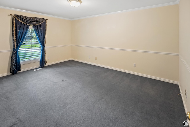 spare room with baseboards, visible vents, dark carpet, and ornamental molding