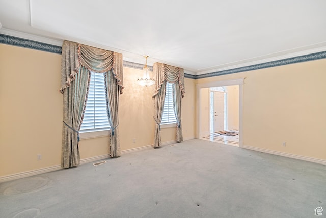 spare room featuring baseboards, visible vents, carpet floors, and ornamental molding