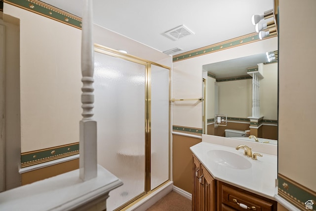 full bathroom featuring vanity, visible vents, and a shower stall