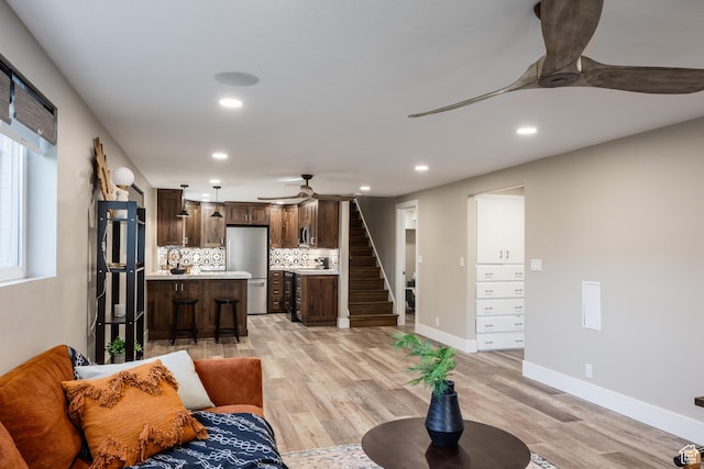 1045 E Claremont Dr S, Bountiful, UT 84010 - living area featuring recessed lighting, a ceiling fan, light wood-type flooring, baseboards, and stairs
