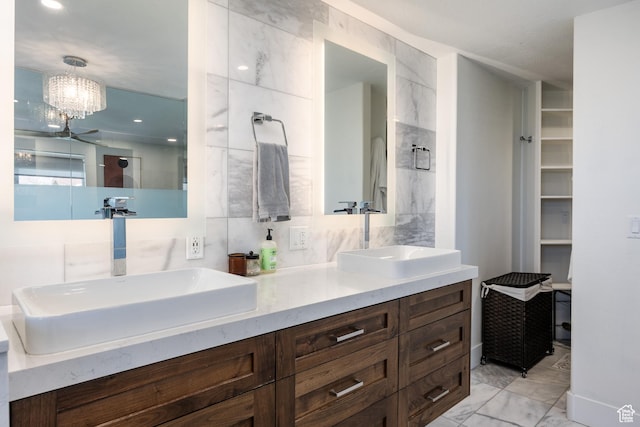 1045 E Claremont Dr S, Bountiful, UT 84010 - full bathroom with an inviting chandelier, marble finish floor, a sink, and double vanity