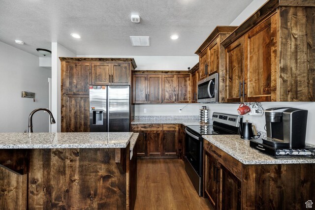 281 N 840 E, Hyrum, UT 84319 - kitchen featuring a textured ceiling, a sink, appliances with stainless steel finishes, dark wood-type flooring, and visible vents