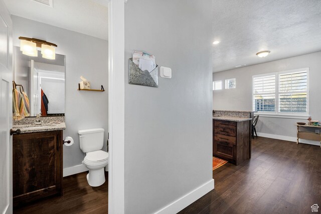 281 N 840 E, Hyrum, UT 84319 - bathroom featuring wood finished floors, vanity, toilet, and baseboards
