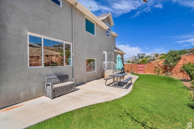 458 E Homespun Cir, Leeds, UT 84746 - rear view of property with a patio area, a lawn, stucco siding, and fence