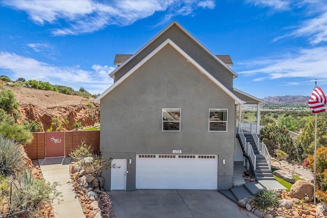 458 E Homespun Cir, Leeds, UT 84746 - view of side of property featuring stairway, stucco siding, fence, and a garage