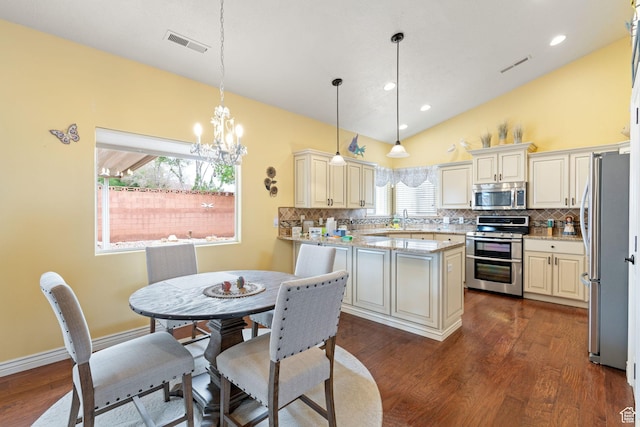 kitchen featuring stainless steel appliances, visible vents, dark wood-type flooring, and tasteful backsplash
