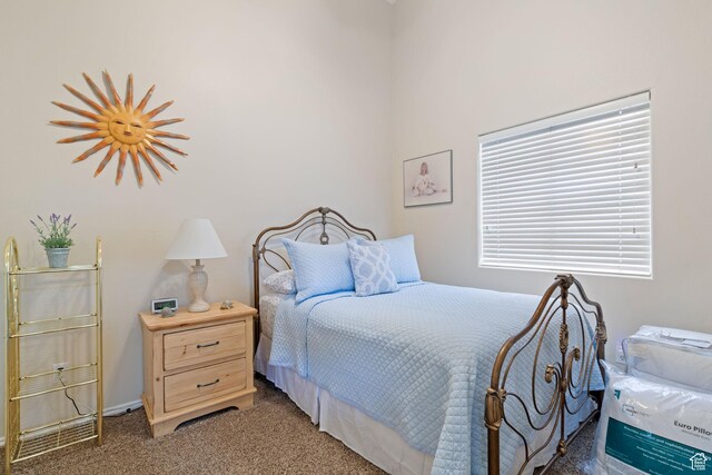 bedroom featuring light carpet and baseboards