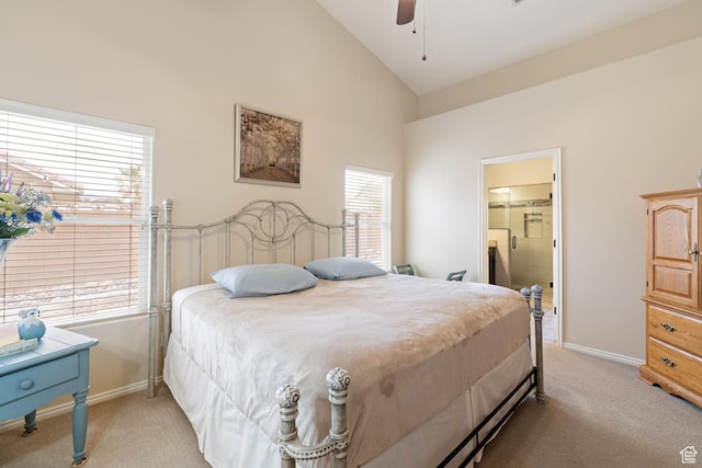 bedroom with a ceiling fan, light carpet, ensuite bath, baseboards, and high vaulted ceiling