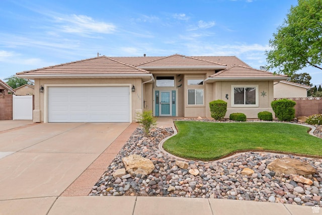 view of front of property featuring a garage, stucco siding, driveway, and a tile roof