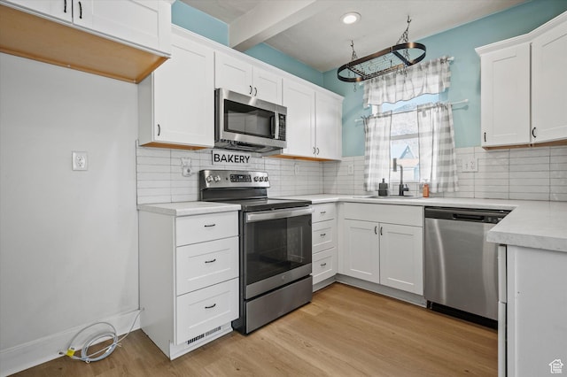 204 S 500 E, Ogden, UT 84404 - kitchen with light countertops, white cabinetry, stainless steel appliances, and a sink