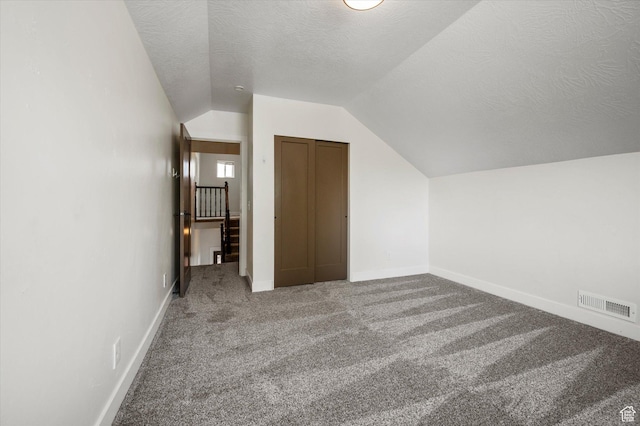 204 S 500 E, Ogden, UT 84404 - additional living space featuring lofted ceiling, carpet, visible vents, baseboards, and a textured ceiling