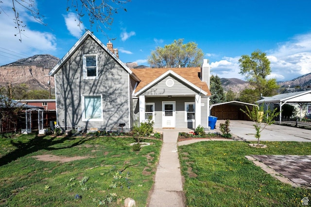 204 S 500 E, Ogden, UT 84404 - view of front of house featuring a detached carport, a front lawn, and a chimney