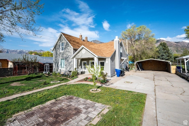 204 S 500 E, Ogden, UT 84404 - bungalow with a chimney, concrete driveway, covered porch, a detached carport, and a front yard