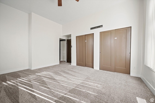 204 S 500 E, Ogden, UT 84404 - unfurnished bedroom with two closets, carpet floors, baseboards, a high ceiling, and visible vents