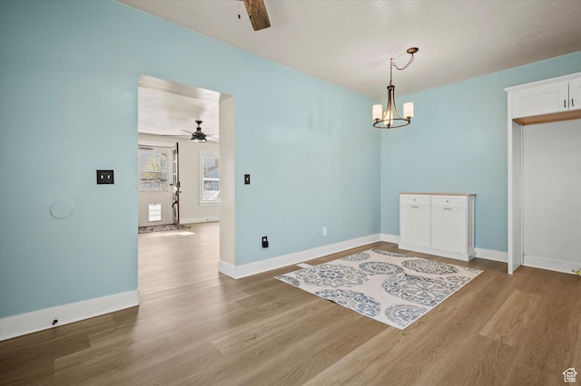 204 S 500 E, Ogden, UT 84404 - spare room featuring baseboards, light wood-type flooring, and ceiling fan with notable chandelier