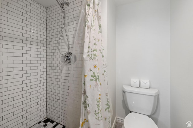3512 S 300 E Unit P, Salt Lake City, UT 84115 - bathroom with toilet, baseboards, and a tile shower