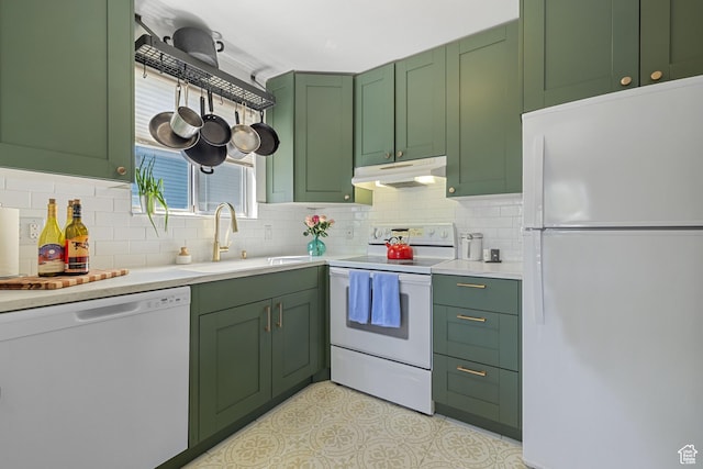 kitchen featuring a sink, green cabinetry, white appliances, light countertops, and under cabinet range hood