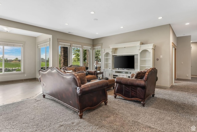 living area with baseboards and recessed lighting