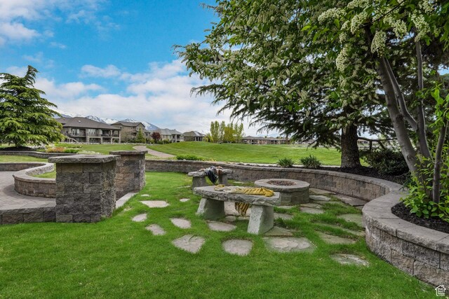 view of yard featuring a residential view and an outdoor fire pit