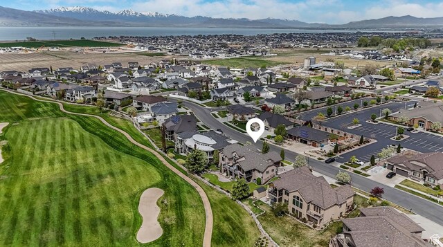 aerial view with a residential view, golf course view, and a water and mountain view
