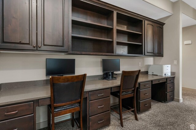 office area with built in study area, carpet floors, and baseboards