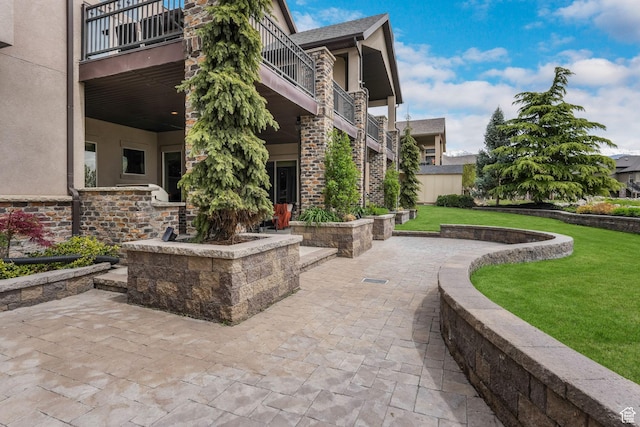 surrounding community with a lawn and a patio area