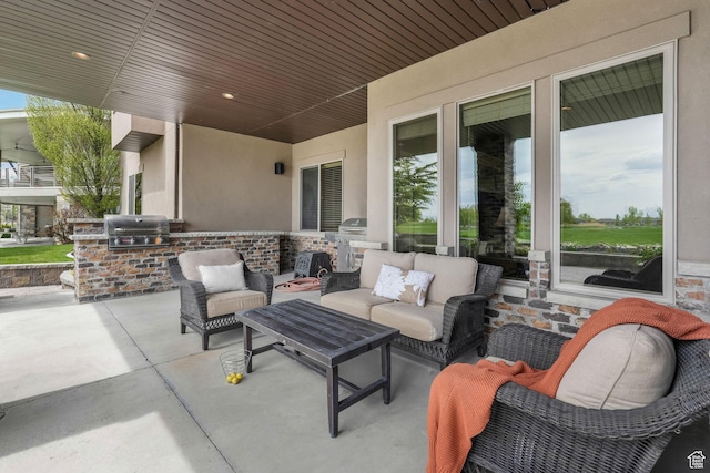 view of patio / terrace featuring an outdoor kitchen, a grill, and an outdoor living space