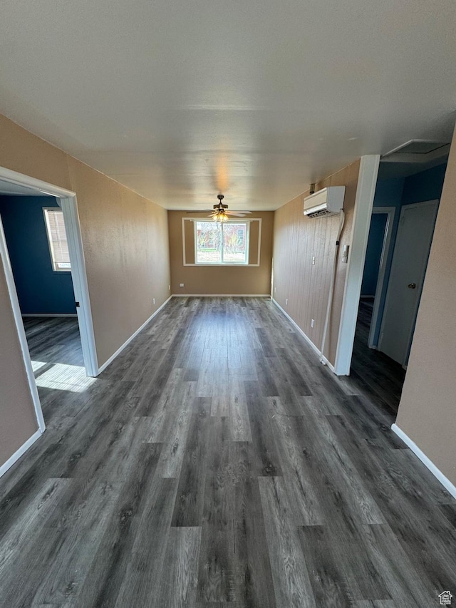 150 Berkley Ave, East Carbon, UT 84520 - interior space with dark wood finished floors, an AC wall unit, ceiling fan, and baseboards