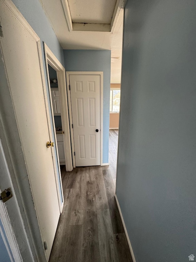 150 Berkley Ave, East Carbon, UT 84520 - hall featuring attic access, baseboards, and dark wood-style floors