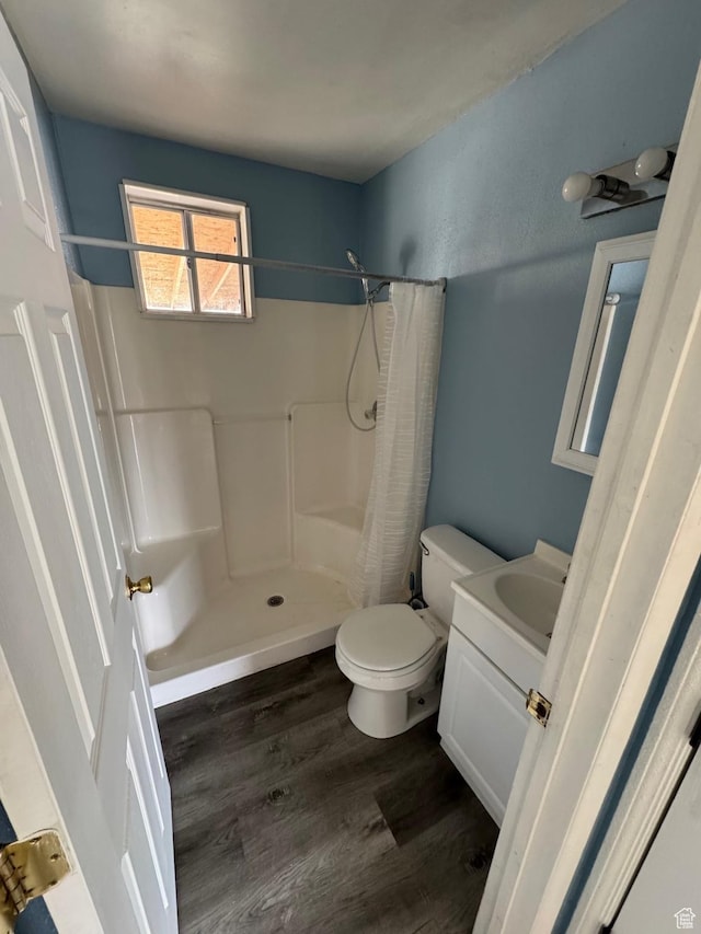 150 Berkley Ave, East Carbon, UT 84520 - full bathroom with a shower with shower curtain, wood finished floors, toilet, and vanity