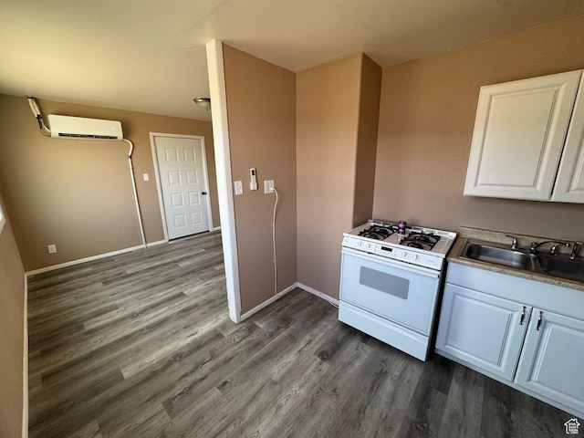 150 Berkley Ave, East Carbon, UT 84520 - kitchen featuring dark wood-style floors, a sink, white cabinetry, white range with gas stovetop, and a wall mounted AC