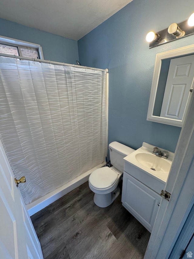 150 Berkley Ave, East Carbon, UT 84520 - full bathroom with toilet, a shower with curtain, vanity, and wood finished floors