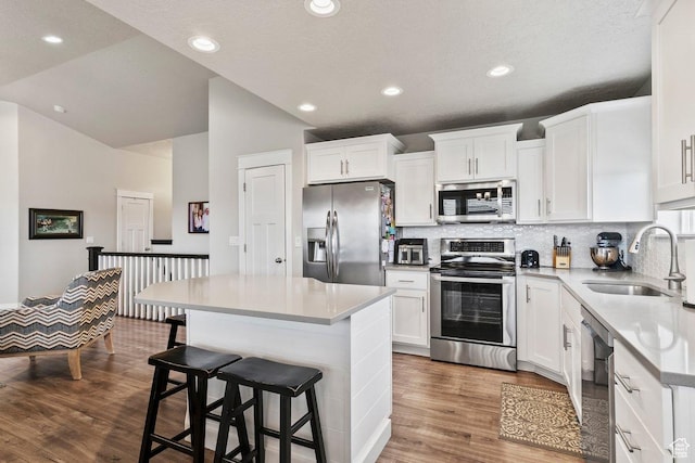 1795 N 4475 W, Plain City, UT 84404 - kitchen featuring decorative backsplash, stainless steel appliances, a sink, and a kitchen island