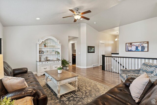 1795 N 4475 W, Plain City, UT 84404 - living room with vaulted ceiling, wood finished floors, ceiling fan, baseboards, and visible vents