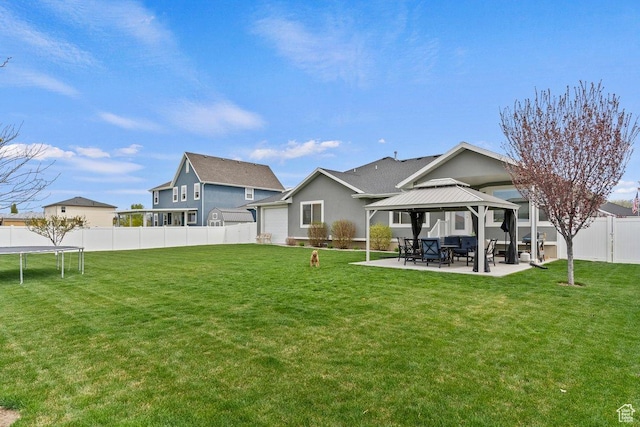 1795 N 4475 W, Plain City, UT 84404 - back of property with a lawn, a gazebo, a patio area, and a trampoline