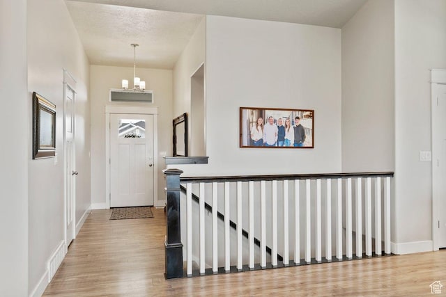 1795 N 4475 W, Plain City, UT 84404 - entrance foyer with a chandelier, wood finished floors, visible vents, and baseboards