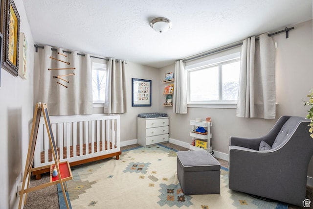 9466 S Indian Ridge Dr E, Sandy, UT 84092 - bedroom with multiple windows, baseboards, a textured ceiling, a crib, and carpet flooring