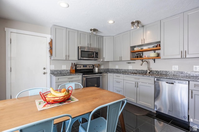 9466 S Indian Ridge Dr E, Sandy, UT 84092 - kitchen with stainless steel appliances, a sink, open shelves, recessed lighting, and a textured ceiling