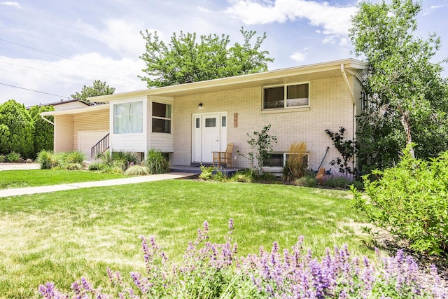 9466 S Indian Ridge Dr E, Sandy, UT 84092 - view of front of house featuring a front yard, a garage, and brick siding