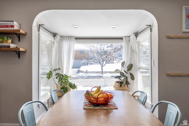 9466 S Indian Ridge Dr E, Sandy, UT 84092 - dining room with arched walkways and a textured ceiling