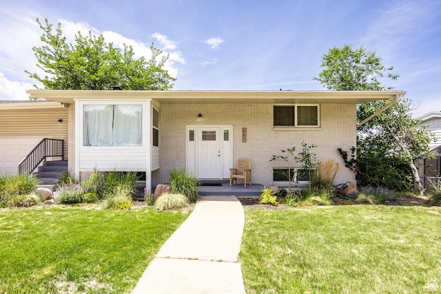9466 S Indian Ridge Dr E, Sandy, UT 84092 - view of front of house with a front yard and covered porch