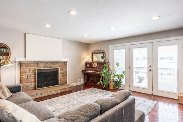 9466 S Indian Ridge Dr E, Sandy, UT 84092 - living area featuring a fireplace, wood finished floors, french doors, recessed lighting, and a textured ceiling