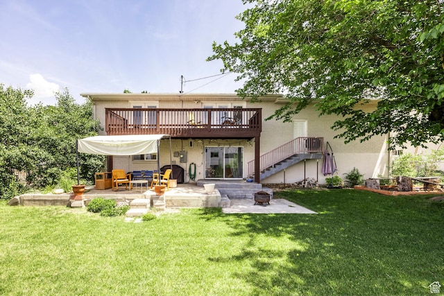 9466 S Indian Ridge Dr E, Sandy, UT 84092 - rear view of property featuring a patio area, a fire pit, a wooden deck, stucco siding, and a lawn
