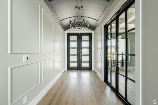 3640 W Kenna Ln Unit 101, Bluffdale, UT 84065 - entryway featuring a decorative wall, a notable chandelier, french doors, and light wood-type flooring