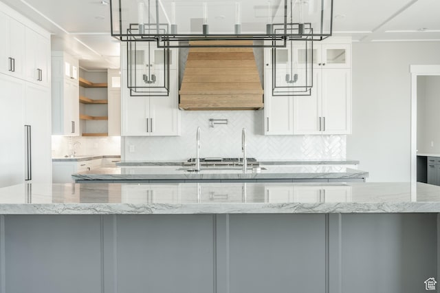 3640 W Kenna Ln Unit 101, Bluffdale, UT 84065 - kitchen featuring open shelves, a sink, light stone countertops, a center island with sink, and tasteful backsplash