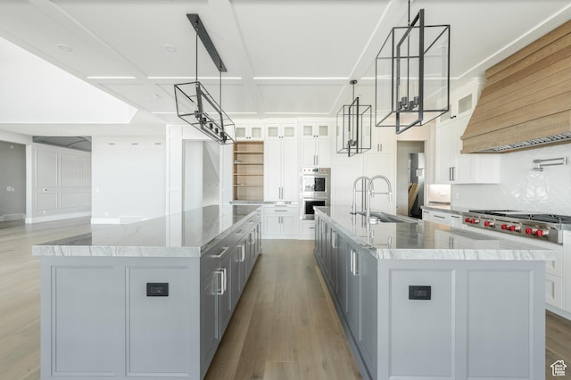 3640 W Kenna Ln Unit 101, Bluffdale, UT 84065 - kitchen featuring a sink, light wood-style floors, a large island, stainless steel appliances, and white cabinets