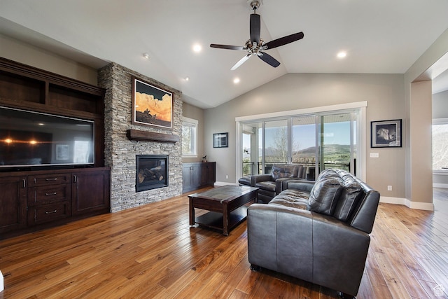 1621 S 4800 E, Heber City, UT 84032 - living room featuring a ceiling fan, light wood finished floors, baseboards, a stone fireplace, and vaulted ceiling