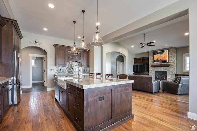 1621 S 4800 E, Heber City, UT 84032 - kitchen with arched walkways, freestanding refrigerator, a sink, a ceiling fan, and dark brown cabinets