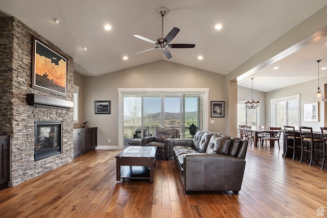 1621 S 4800 E, Heber City, UT 84032 - living room featuring wood-type flooring, a stone fireplace, ceiling fan, healthy amount of natural light, and high vaulted ceiling