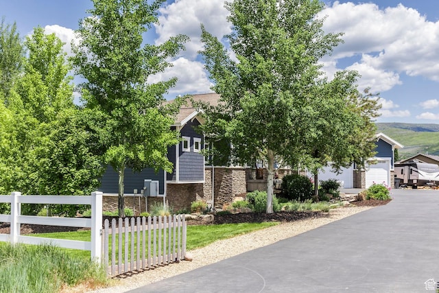 1621 S 4800 E, Heber City, UT 84032 - view of property hidden behind natural elements with stone siding, driveway, and a garage